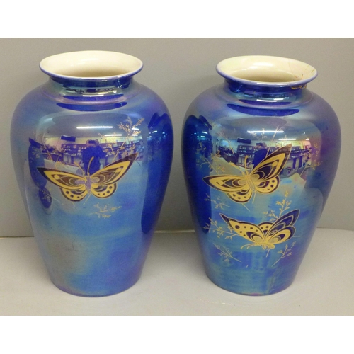 632 - A pair of Devon ware lustre butterfly vases, a/f, restored rim on one and star crack on base to the ... 