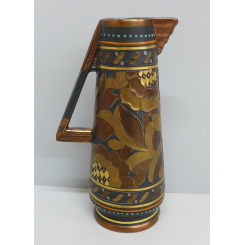 653 - An Art Deco tube lined small pitcher, signed Rhead, 228 to base, 19.5cm