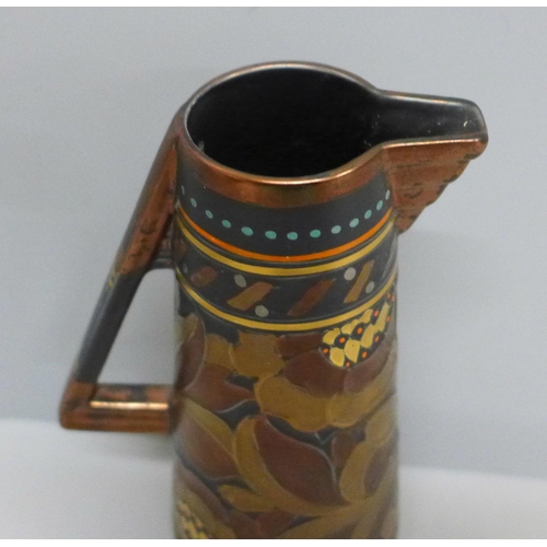 653 - An Art Deco tube lined small pitcher, signed Rhead, 228 to base, 19.5cm