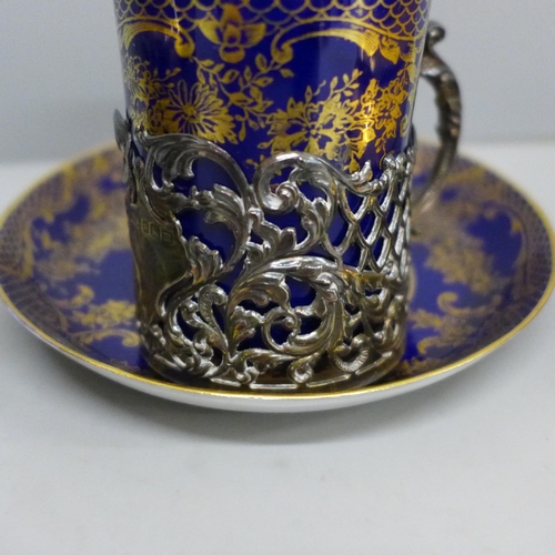 661 - A silver holder with Staffordshire porcelain coffee can and saucer and three pieces of Limoges china