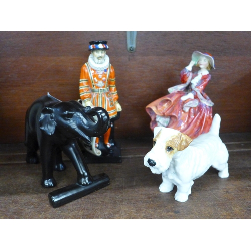 710 - Two Royal Doulton figures, Top of the Hill and Beefeater, Royal Doulton terrier and a model of an el... 