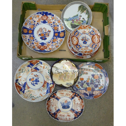 750 - A collection of Japanese Imari pattern chargers and plates and other oriental plates