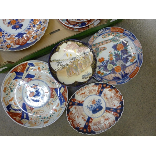 750 - A collection of Japanese Imari pattern chargers and plates and other oriental plates