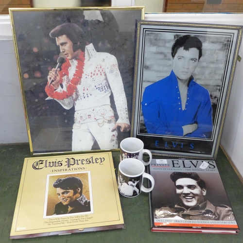 797 - A collection of Elvis Presley items including two prints, framed, two mugs, four records and a book