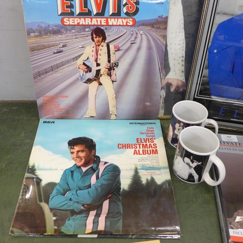 797 - A collection of Elvis Presley items including two prints, framed, two mugs, four records and a book