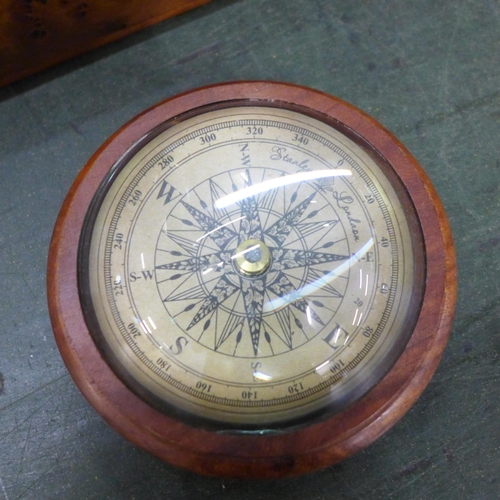 803 - A student's field microscope, three bells, carved walnut dominoes and a compass