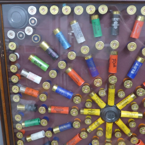 808A - A collection of empty gun cartridges mounted in a frame, 66cm x 66.5cm **PLEASE NOTE THIS LOT IS NOT... 