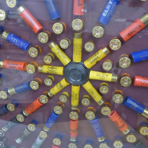 808A - A collection of empty gun cartridges mounted in a frame, 66cm x 66.5cm **PLEASE NOTE THIS LOT IS NOT... 