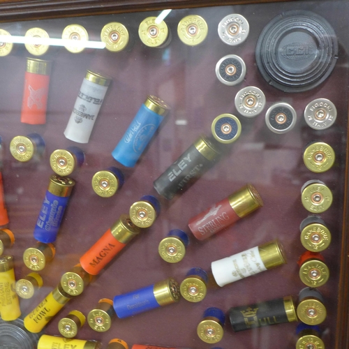 808A - A collection of empty gun cartridges mounted in a frame, 66cm x 66.5cm **PLEASE NOTE THIS LOT IS NOT... 