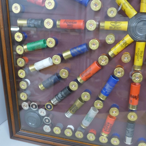 808A - A collection of empty gun cartridges mounted in a frame, 66cm x 66.5cm **PLEASE NOTE THIS LOT IS NOT... 