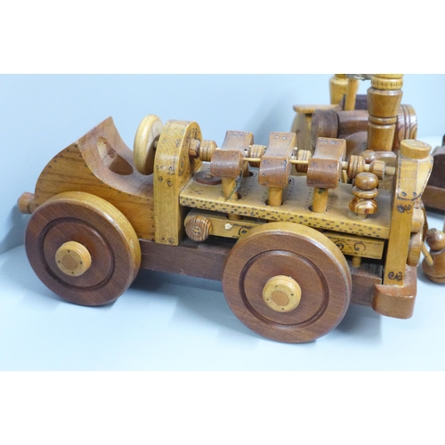 821 - Two Paul Reardon hand made wooden models of a car and a steam roller, together with another wooden m... 