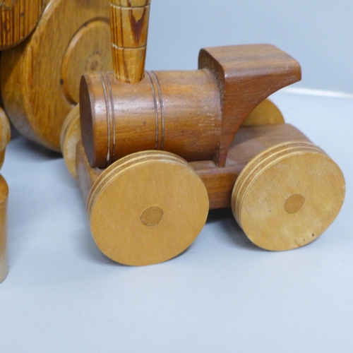 821 - Two Paul Reardon hand made wooden models of a car and a steam roller, together with another wooden m... 