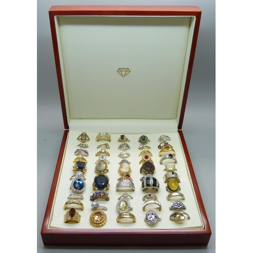 904 - Fifty costume rings in a case