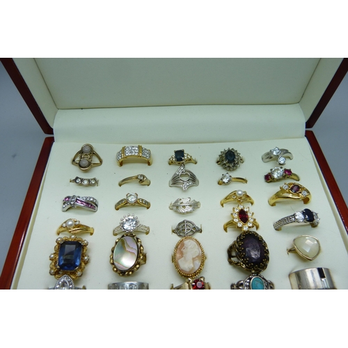 904 - Fifty costume rings in a case