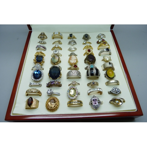 904 - Fifty costume rings in a case