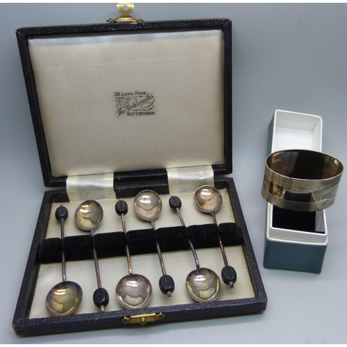 913 - A cased set of six silver coffee bean spoons by Elkington and a silver napkin ring, 60g