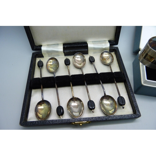 913 - A cased set of six silver coffee bean spoons by Elkington and a silver napkin ring, 60g