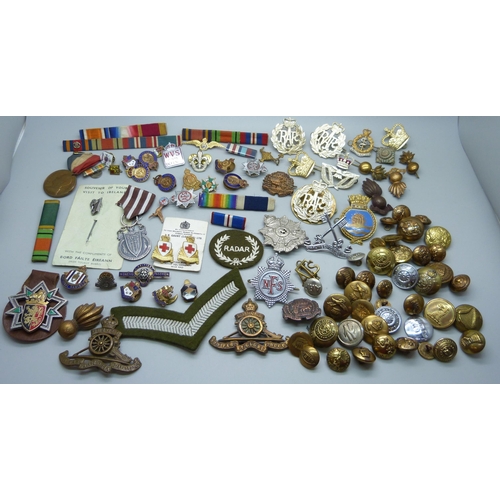 940 - A collection of military badges, uniform badges, other badges, etc.