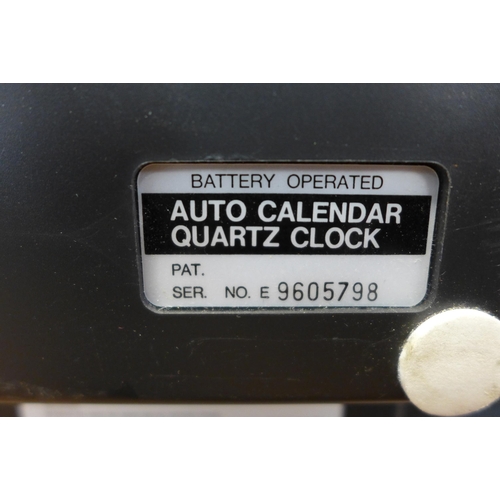 2128 - A battery operated auto calendar quarts clock