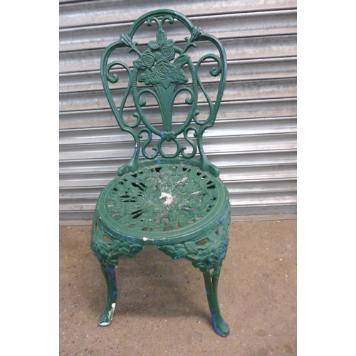 2131 - A three piece cast metal garden set with two chairs and a circular table