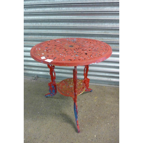 2131 - A three piece cast metal garden set with two chairs and a circular table