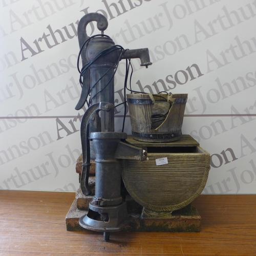 2154 - Two garden water features - one cast iron effect water pump and a cast iron water pump with a barrel