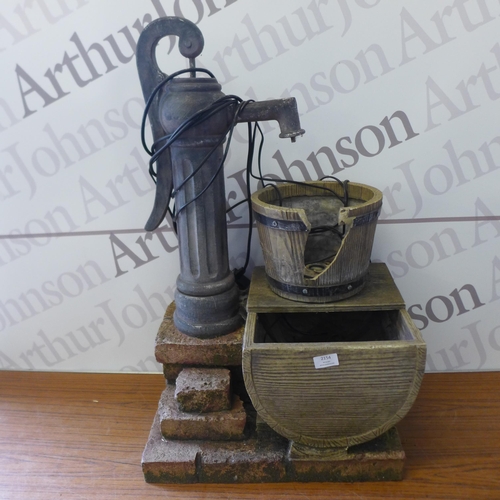 2154 - Two garden water features - one cast iron effect water pump and a cast iron water pump with a barrel