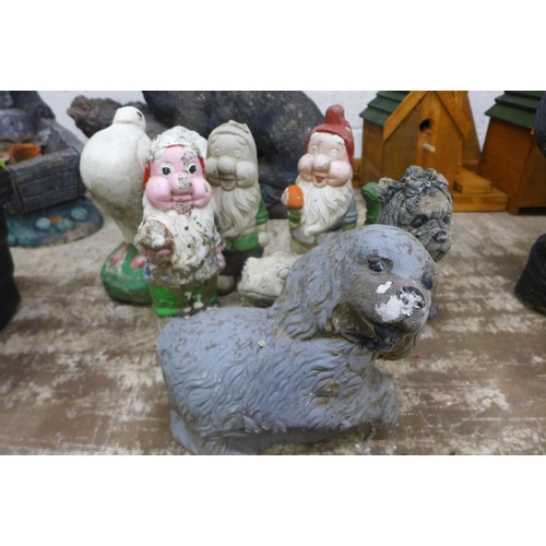 2162 - An assortment of concrete garden ornaments including gnomes, a dove, a mole, dogs, a frog etc.