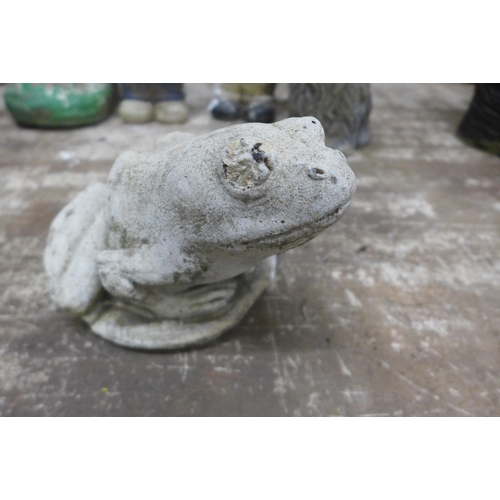 2162 - An assortment of concrete garden ornaments including gnomes, a dove, a mole, dogs, a frog etc.