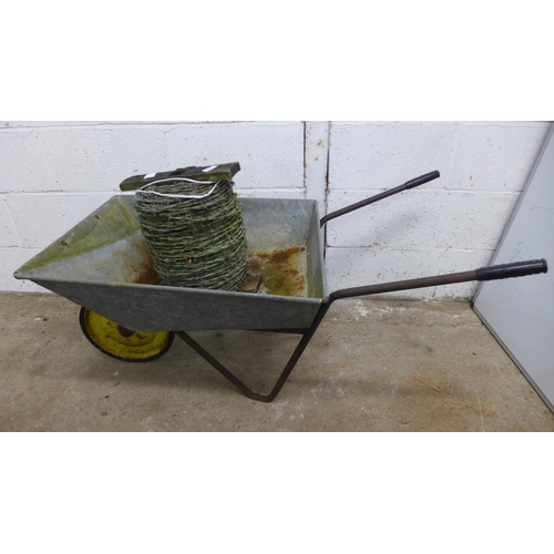 2180 - A roll of barbed wire and a metal wheelbarrow