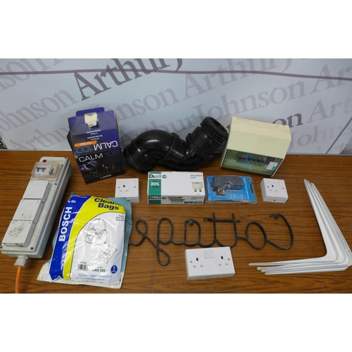 2246 - A box of assorted household items including- camping hook up cable, lights, hoover bags, L brackets ... 