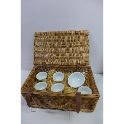 2284 - A box of assorted household items including a wicker basket, glassware, a metal commemorative plate,... 