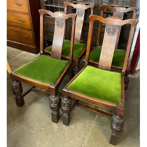 99 - A set of four carved oak dining chairs