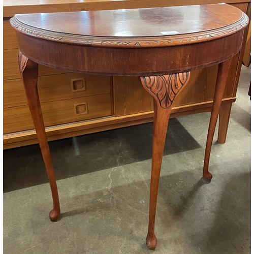 100 - A Queen Anne style carved  mahogany demi-lune hall table