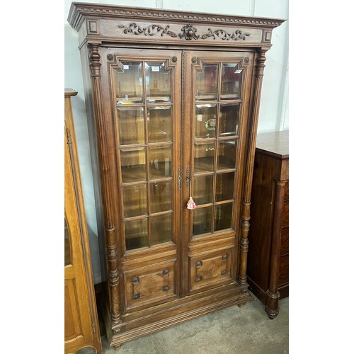 104 - A 19th Century French carved walnut two door bookcase