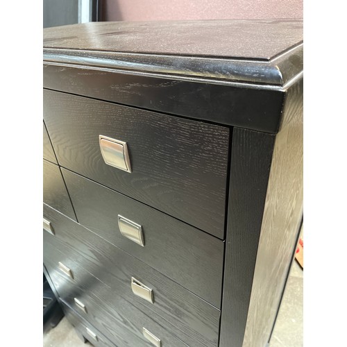 1496 - A black ash chest of eight drawers