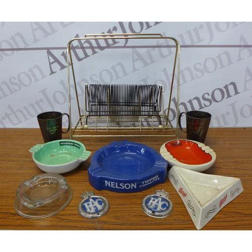 2245 - A collection of vintage brewery ashtrays and top badges