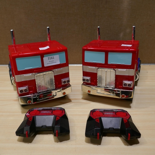 3161 - 2x R/C Transformers Optimus Prime with remotes (324-53) *This lot is subject to vat