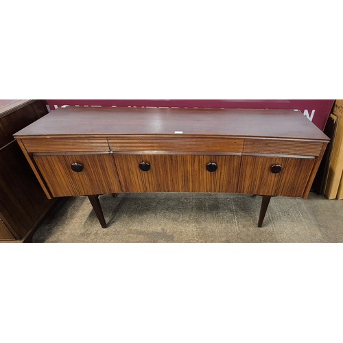 23 - An Elliotts of Newbury afromosia concave sideboard