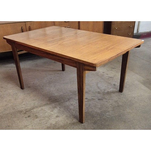 28 - A teak extending dining table