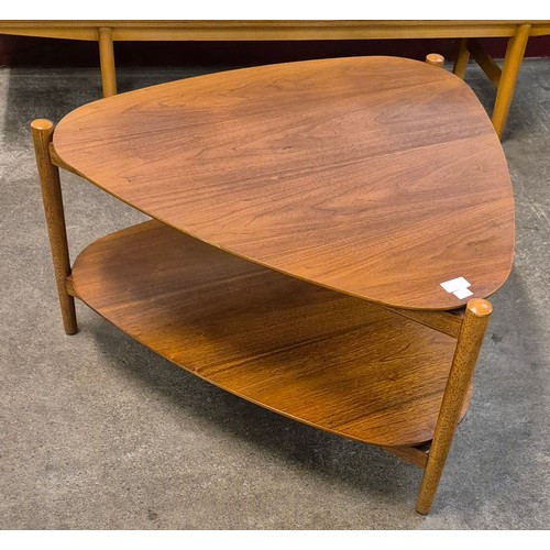 53 - A teak triangular two tier coffee table