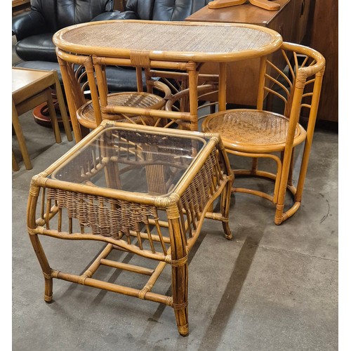 100 - A bamboo and rattan table and two chairs and a glass topped table