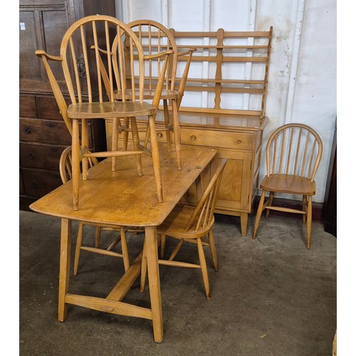 99 - An Ercol elm and beech dining suite, comprising; dining table, five chairs and a dresser