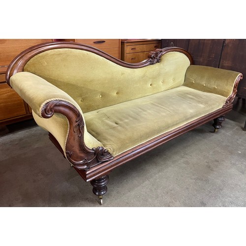 120 - An early Victorian mahogany and green fabric upholstered scroll arm settee