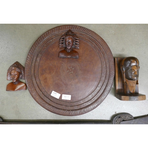 1143 - Carved wooden pieces from Papua New Guinea including a table top and a paddle **PLEASE NOTE THIS LOT... 