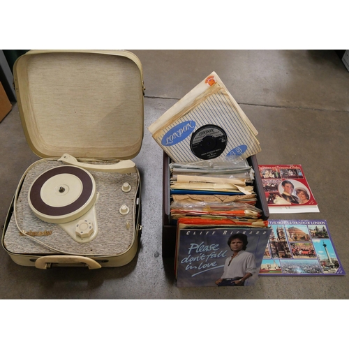 1157 - A Westminster suitcase record player with a box of 7