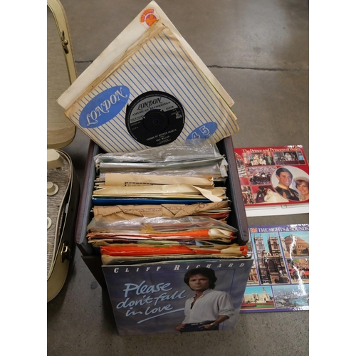 1157 - A Westminster suitcase record player with a box of 7