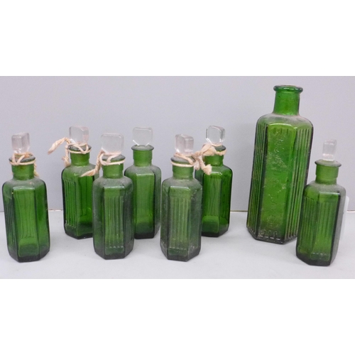 611 - Eight green glass medicine bottles, one lacking stopper