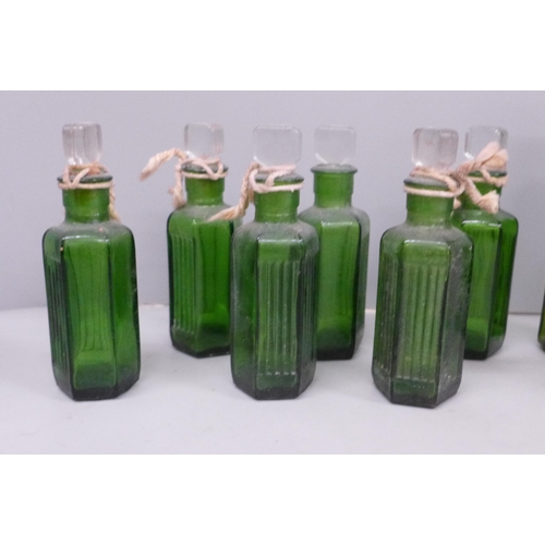 611 - Eight green glass medicine bottles, one lacking stopper