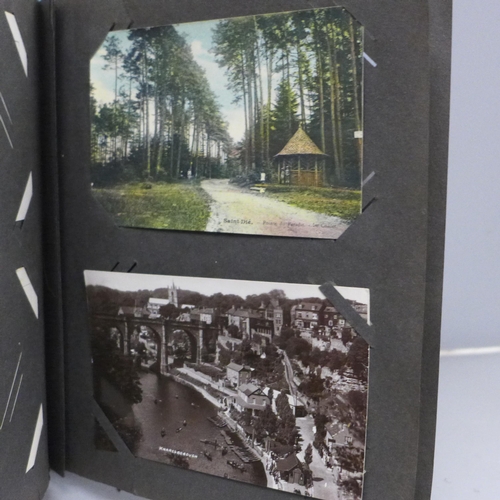 613 - A vintage postcard album containing 92 postcards